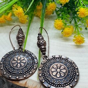 Beautiful copper pendant with flower design. Set on 35mm copper kidney wire.